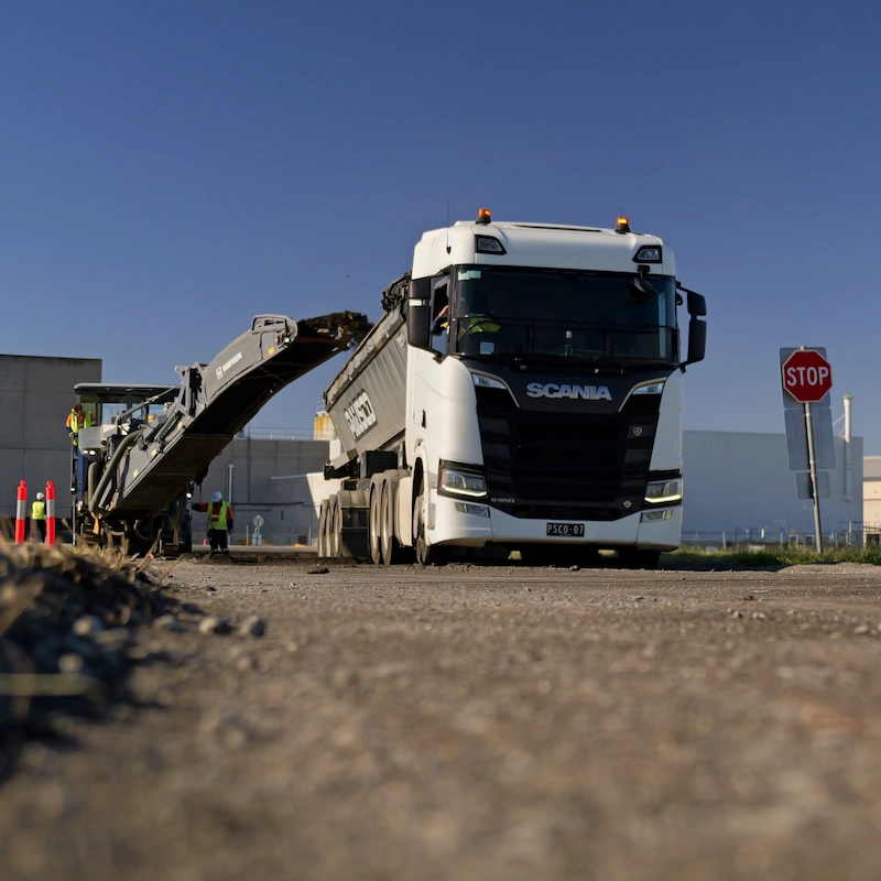 Scania truck and milling equipment operating on the airside maintenance road